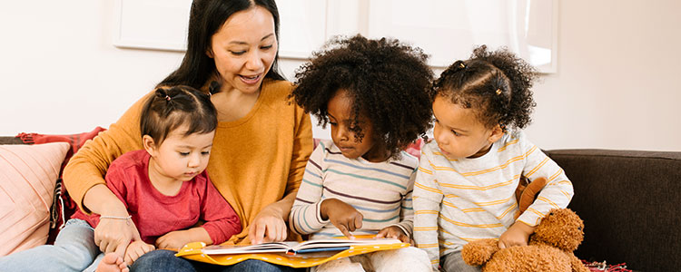 Kids reading with caregiver